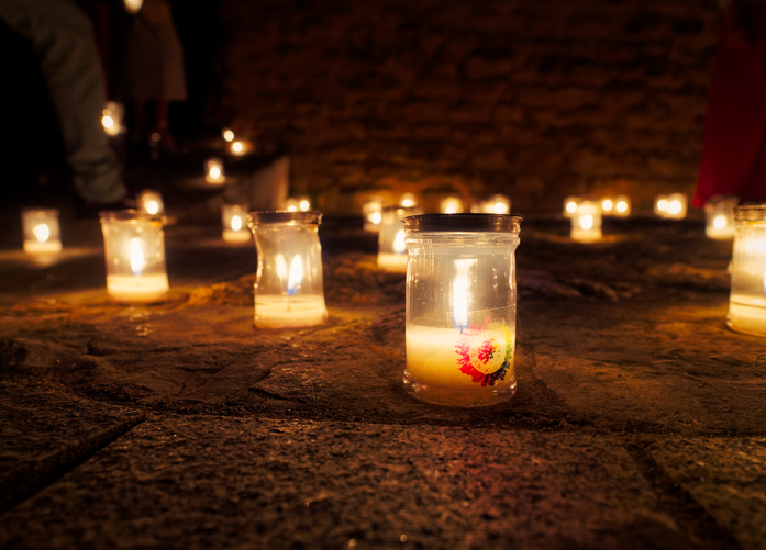 Close-Up Of Illuminated Tea Light Candles In Church