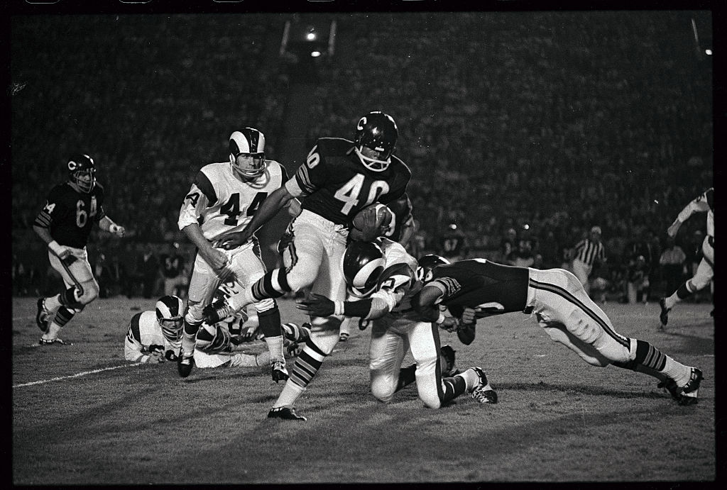 Gale Sayers Gets Hit Carrying Football