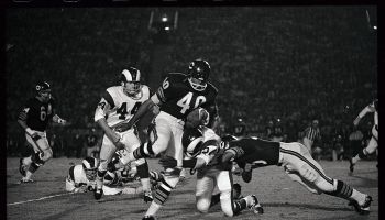 Gale Sayers Gets Hit Carrying Football