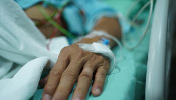 Patient's hand with saline intravenous.