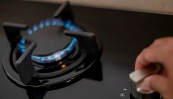 Unrecognizable Woman Turning On Gas Stove
