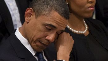 US President Barack Obama wipes away a t