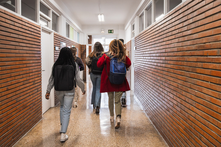 High school students walking down school hallway